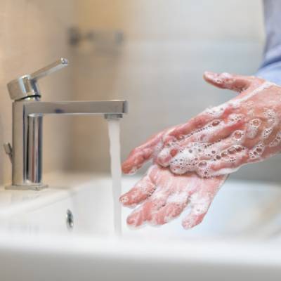 Staff sanitising hands before handling food